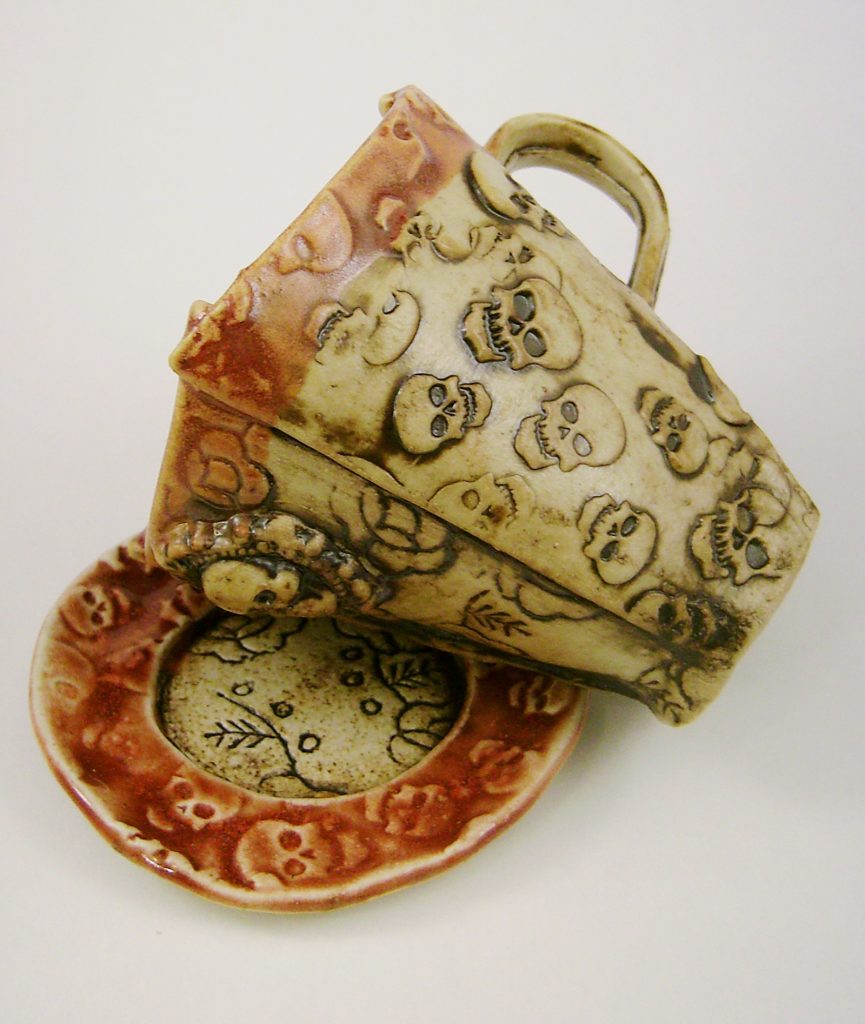 Teacup and saucer with skulls